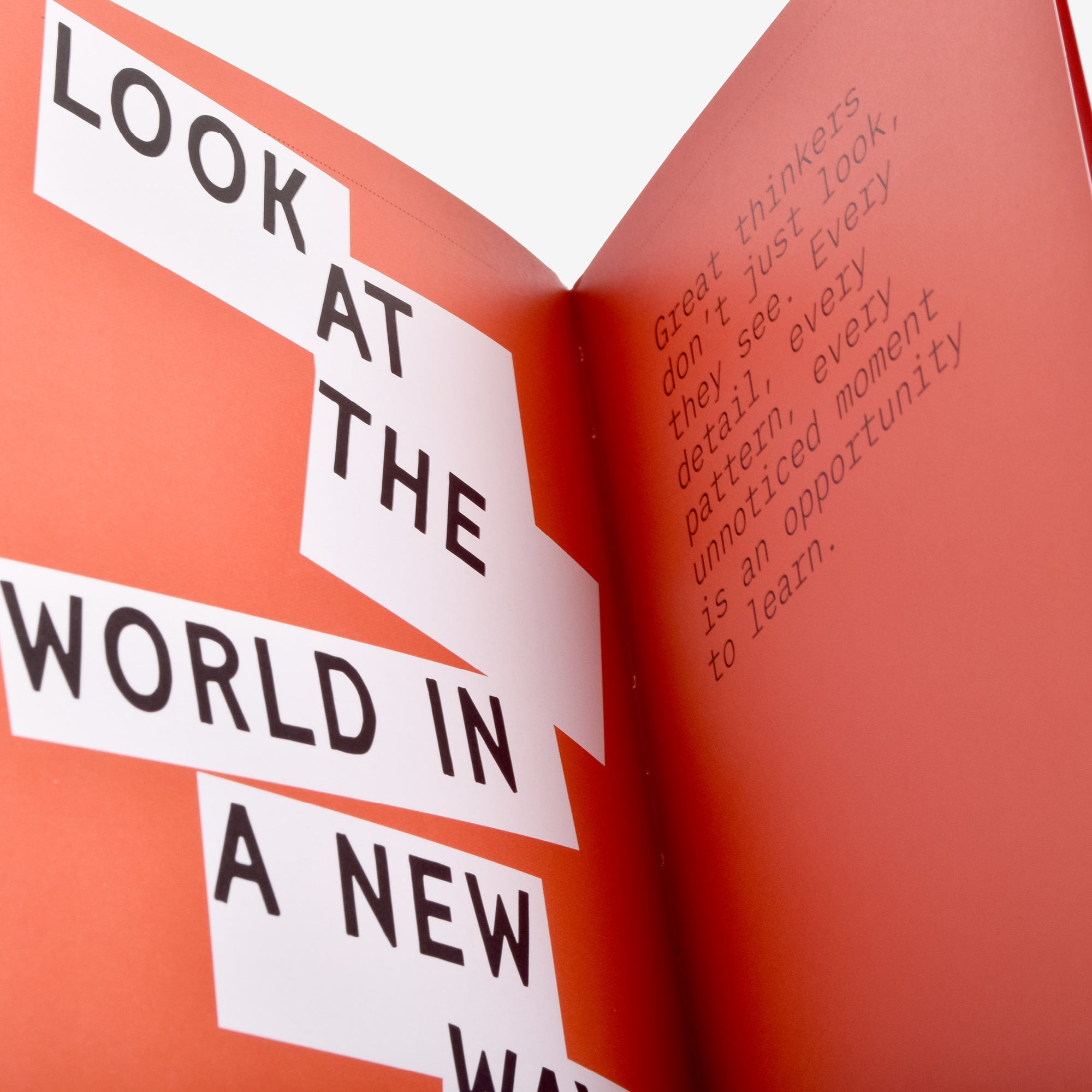 Open book with motivational opening chapter text "Great thinkers don't just look, they see. Every detail, every pattern, every unnoticed moment is an opportunity to learn."  on a red background