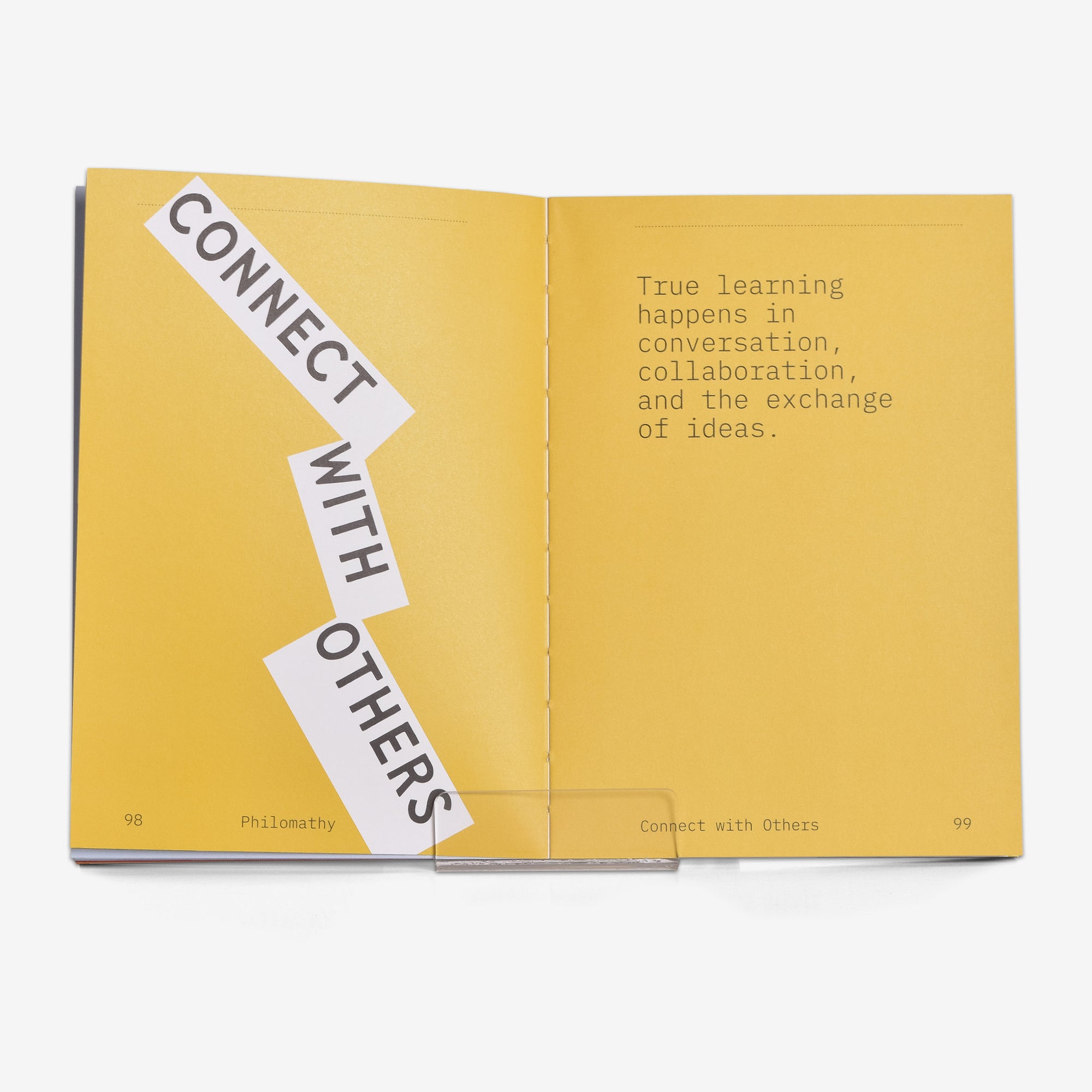 Open book with yellow pages displaying opening text for a chapter about connecting with others and true learning.