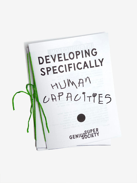 The cover of a zine called Developing Specifically Human Capacities written in our custom font with a bold black dot and bound with green thread