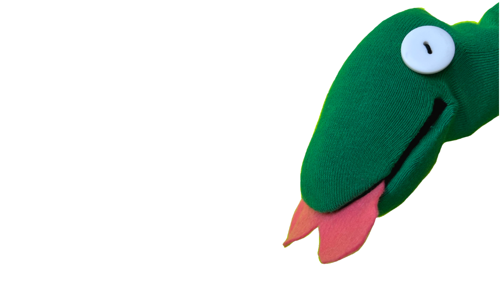 A green snake sock puppet called Scribble with a pink felt heart tongue and button eyes looking inquiringly